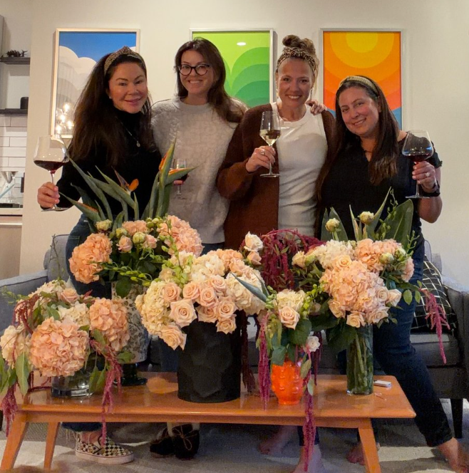 Guests at an arrangement night with their bouquets