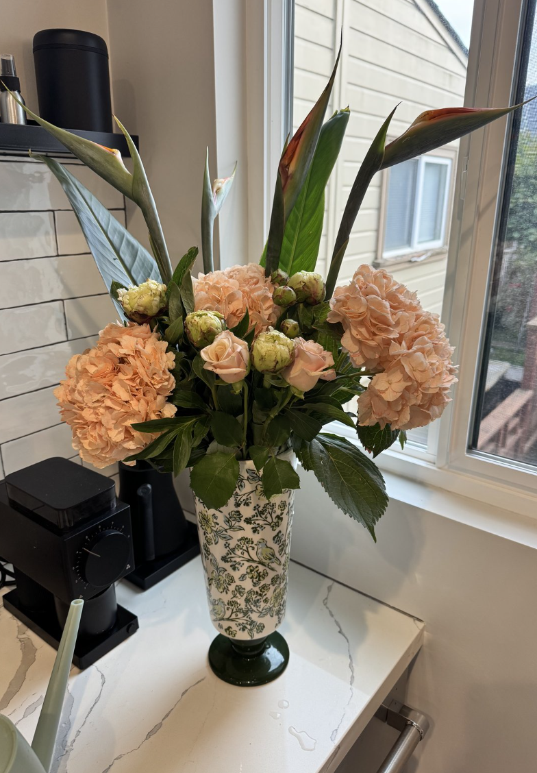 A finished arrangement in a patterned vase
